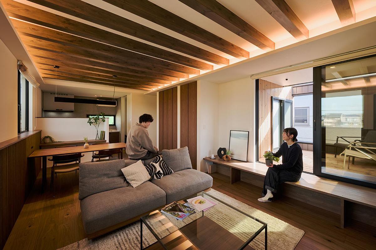木の質感に包まれたLDK。窓辺のベンチは腰掛けにも飾り棚にもなる多用途な設えで、暮らしにゆとりを添える